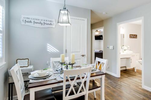 a dining room with a table and white chairs at Step-Free Home with Fire Pit - 3 Miles to USC! in Columbia