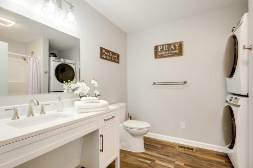 a white bathroom with a sink and a toilet at Step-Free Home with Fire Pit - 3 Miles to USC! in Columbia