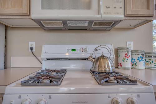 a tea kettle sitting on top of a stove in a kitchen at Seaside Vacation Rental - Meredith Lodging in Seaside