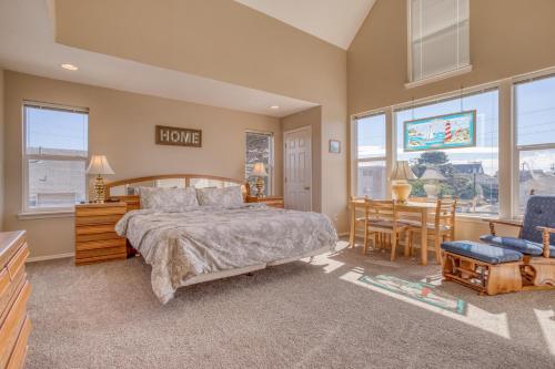 a bedroom with a bed and a table and chairs at Seaside Vacation Rental in Seaside