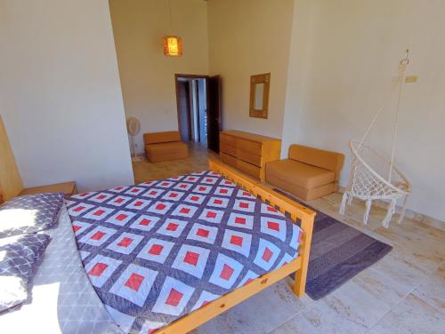 a bedroom with a bed and a swing at Kasakai Beachouse in Juan Gallego
