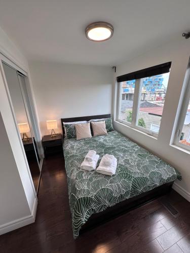 a bedroom with a bed with two pillows on it at Toronto GREAT Located in Toronto