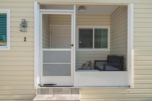 an open door on a house with a chair at Downtown Dunedin Gem, Fully Renovated #2 in Dunedin