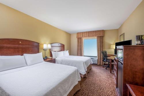 a hotel room with two beds and a television at Hampton Inn & Suites Oklahoma City - South in Oklahoma City