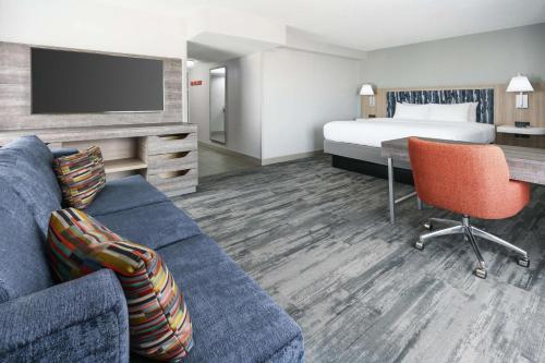 a hotel room with a bed and a couch at Hampton Inn & Suites Tampa Ybor City Downtown in Tampa