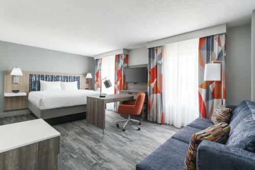 a hotel room with a bed and a desk at Hampton Inn & Suites Tampa Ybor City Downtown in Tampa
