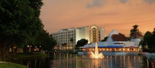 a hotel with a fountain in the middle of a lake at Hilton Boca Raton Suites in Boca Raton