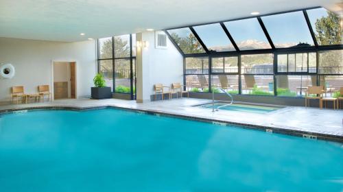 una piscina en una casa con ventanas en Embassy Suites by Hilton Colorado Springs, en Colorado Springs