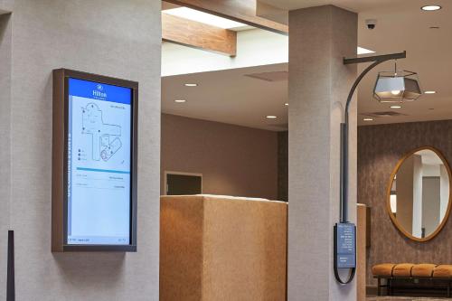 a projection screen on a wall in a lobby at Hilton Cincinnati Airport in Florence