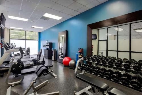 a gym with treadmills and cardio machines at Embassy Suites by Hilton Dallas-Love Field in Dallas
