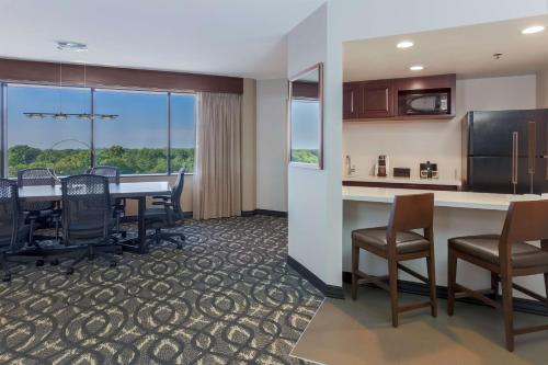 a kitchen and dining room with a table and chairs at Embassy Suites by Hilton Dallas-Love Field in Dallas