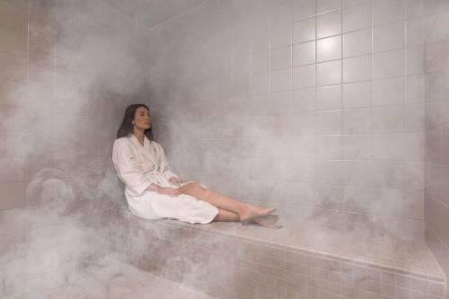 a woman sitting in a bathtub in a room at Royale Palms Condominiums in Myrtle Beach