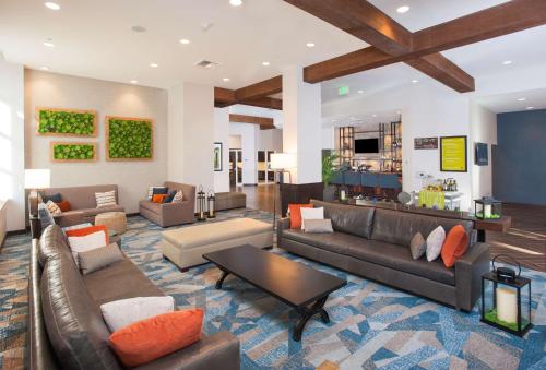 a large living room with couches and a table at Hilton Garden Inn Burbank Los Angeles in Burbank