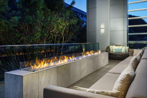 a fire feature in a patio with couches at Hampton Inn & Suites Santa Monica in Los Angeles