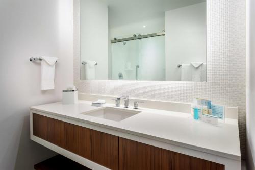 a bathroom with a sink and a mirror at Hampton Inn & Suites Santa Monica in Los Angeles