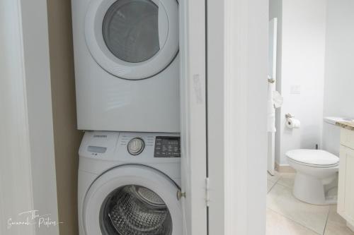 a laundry room with a washer and dryer at Sparkling & Spacious - Waterfront - 2bd,2ba - Sleeps 8 in Fort Pierce