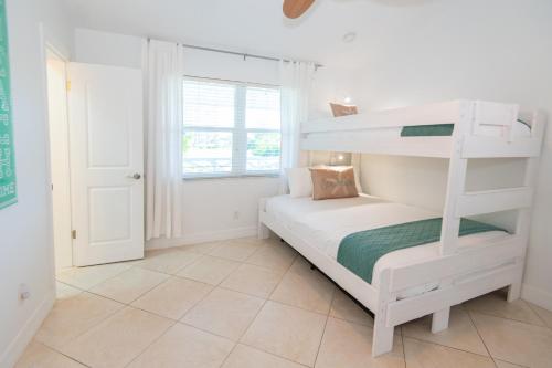a bedroom with a bunk bed and a window at Sparkling & Spacious - Waterfront - 2bd,2ba - Sleeps 8 in Fort Pierce