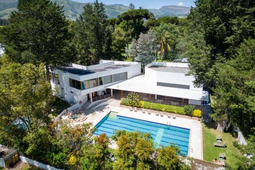 an aerial view of a house with a swimming pool at San Jose De Puembo Quito Airport, An Ascend Hotel Collection in Puembo