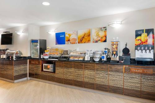 a restaurant with a counter with food on it at Comfort Inn Edinburgh - Columbus in Edinburgh