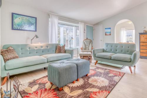 a living room with two blue couches and a rug at Nigh Tides in Yachats