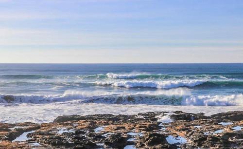 a group of waves crashing on a rocky beach at Nigh Tides in Yachats