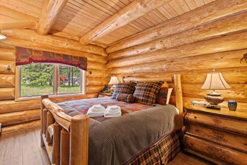 um quarto com uma cama num chalé de madeira em Big Jim Mountain Lodge em Leavenworth