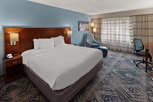a hotel room with a large bed and a desk at Best Western Spartanburg Northwest in Spartanburg