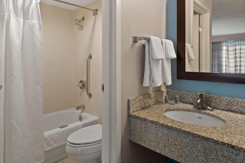 a bathroom with a sink and a toilet and a mirror at Best Western Spartanburg Northwest in Spartanburg