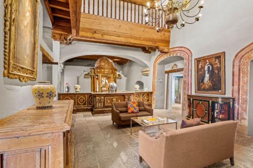 a living room filled with furniture and a chandelier at Quinta Real Puebla in Puebla