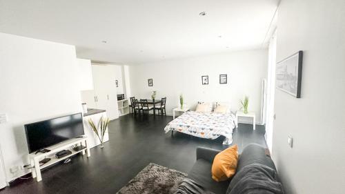 a living room with a couch and a table at Le Color Spot - Porte de Paris in Pantin