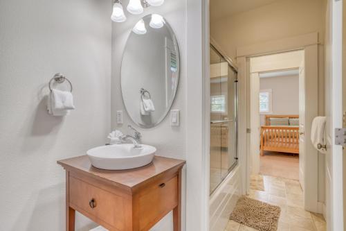 a bathroom with a sink and a mirror at Pacific Way Cottage - Meredith Lodging in Gearhart