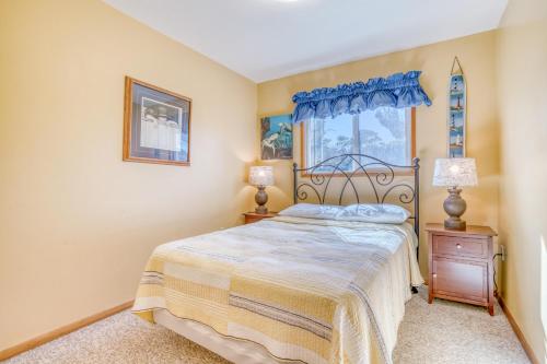 a bedroom with a bed and a window at A Pelicans Perch in Lincoln City