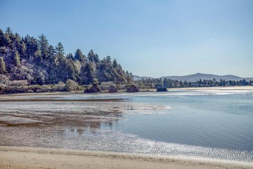 a view of a beach with trees and water at A Pelicans Perch in Lincoln City