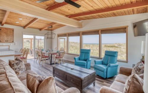 a living room with a couch and chairs and a table at On the Sand MCA 198 - Meredith Lodging in Manzanita