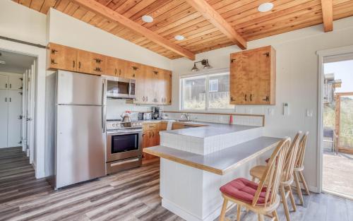 a kitchen with wooden ceilings and a wooden floor at On the Sand MCA 198 - Meredith Lodging in Manzanita