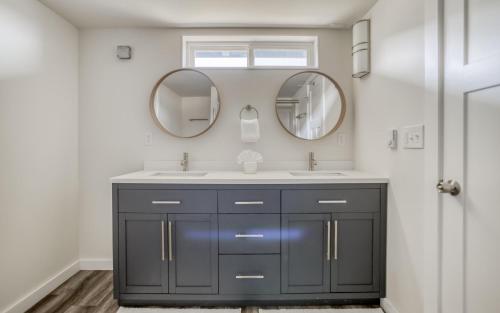 a bathroom with two sinks and two mirrors at On the Sand MCA 198 - Meredith Lodging in Manzanita