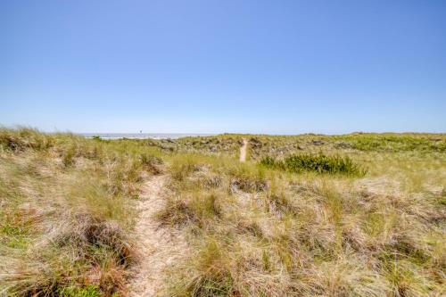 a path in a field of grass with a blue sky at On the Sand MCA 198 - Meredith Lodging in Manzanita