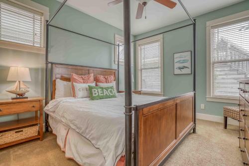 a bedroom with a four poster bed with a ceiling fan at Barnacle Bay in Lincoln City