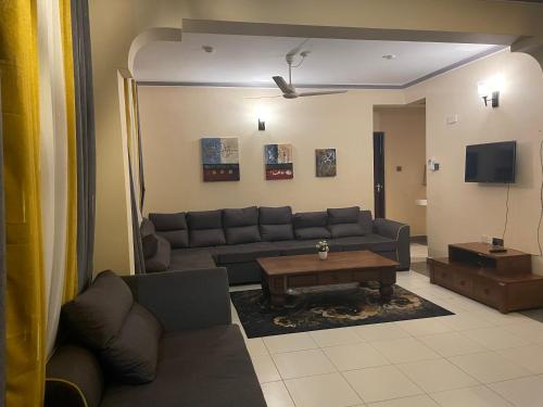 a living room with a couch and a coffee table at The Tropics Apartment Mombasa in Mombasa