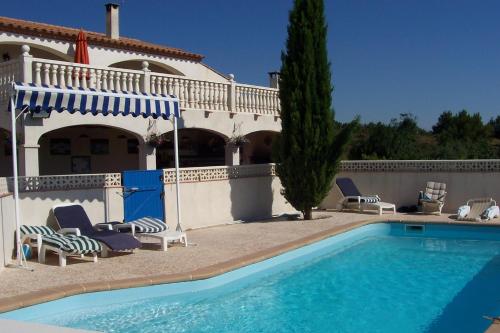 a swimming pool in front of a house at Le Fenouillet Chambres D'hotes proche des Grands Buffets in Narbonne