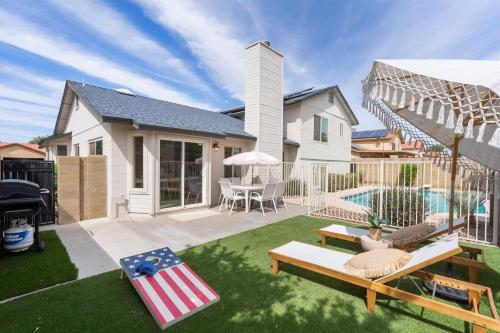 a backyard with a pool and a house at Gilbert Getaway - pool+games+pool table in Gilbert