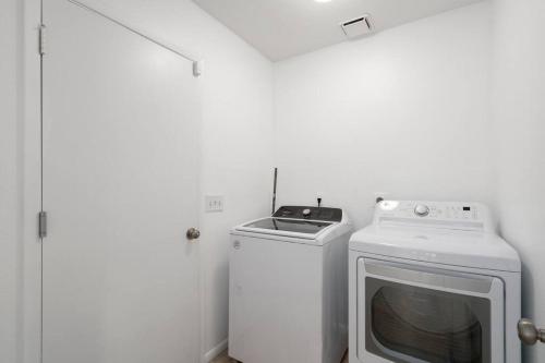 a laundry room with a washing machine and a washer at Gilbert Getaway - pool+games+pool table in Gilbert