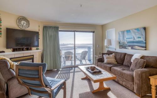 a living room with a couch and a table at Waters Edge 407 in Lincoln City