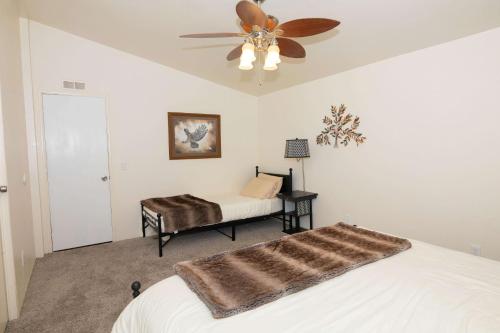 a bedroom with a bed and a ceiling fan at HERITAGE HOUSE GREAT FOR GROUPS!!! in Pahrump