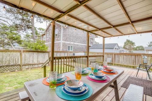 a table with plates of food on a deck at Slack Tide - Meredith Lodging in Seaside