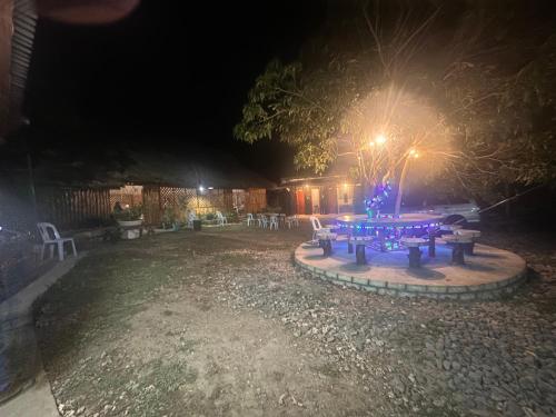 a picnic table in a yard at night at Gratum Beach Resort in Dapitan
