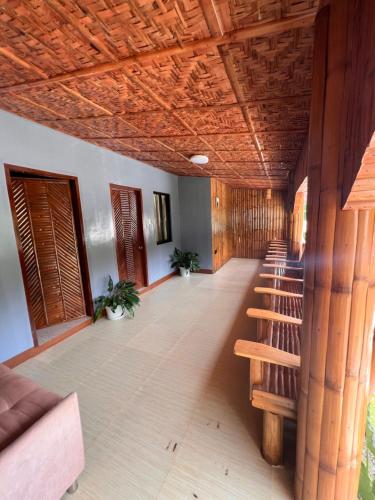 a hallway with a row of benches and a wooden ceiling at Gratum Beach Resort in Dapitan