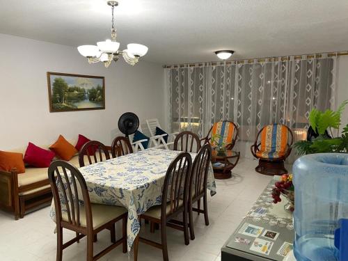 Un comedor con una mesa y sillas y un sofá. en Apartamentos Salome, en San Andrés