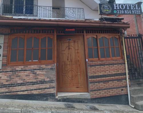 a building with a large wooden door and windows at Hotel Estambul in Amagá