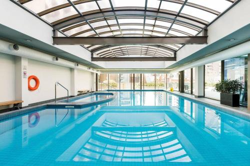 a pool with two swimming pools with a ceiling at HeartCBD LUX Top Floor 2 Bedroom /Pool/Spa/GYM in Melbourne